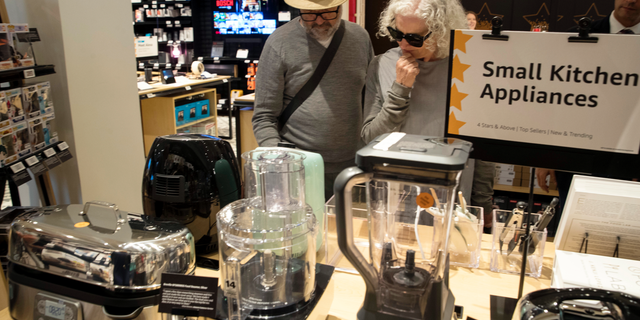 FILE- In this Sept. 27, 2018, file photo shoppers browse the items on display at the Amazon 4-star store in the Soho neighborhood of New York. On Tuesday, Oct. 30, the Conference Board releases its October index on U.S. consumer confidence. (AP Photo/Mary Altaffer, File)
