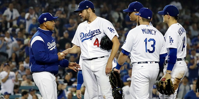 Los Angeles Dodgers pitcher Rich Hill is relieved by Los Angeles Dodgers manager Dave Roberts during the seventh inning in Game 4 of the World Series baseball game on Saturday, Oct. 27, 2018, in Los Angeles. (AP Photo/David J. Phillip)
