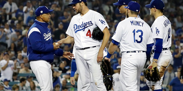 Los Angeles Dodgers pitcher Rich Hill is relieved by Los Angeles Dodgers manager Dave Roberts during the seventh inning in Game 4 of the World Series baseball game on Saturday, Oct. 27, 2018, in Los Angeles. (AP Photo/David J. Phillip)