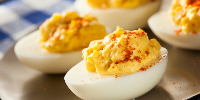 A selection of delicious deviled eggs are shown here — keep this recipe handy for your next gathering or event!