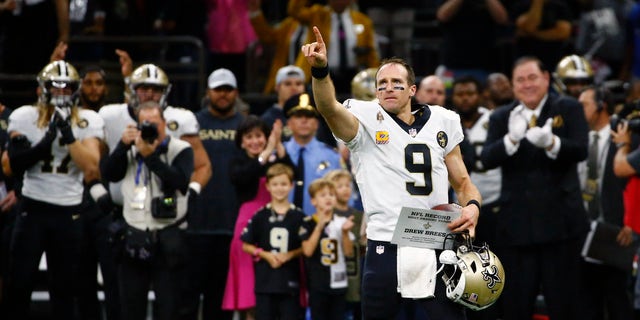 New Orleans Saints quarterback Drew Brees (9) responds to the crowd after breaking the NFL all-time passing yards record in the first half of an NFL football game against the Washington Redskins in New Orleans, Monday, Oct. 8, 2018. (AP Photo/Butch Dill)