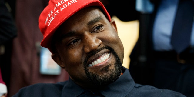 Rapper Kanye West smiles as he listens to a question from a reporter during a meeting in the Oval Office of the White House with President Trump Thursday, Oct. 11, 2018, in Washington.