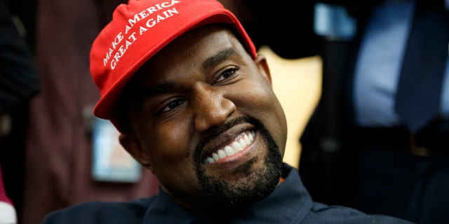Rapper Kanye West smiles as he listens to a question from a reporter during a meeting in the Oval Office of the White House with President Trump Thursday, Oct. 11, 2018, in Washington.