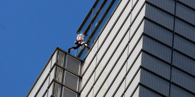 Alain Robert, an urban climber dubbed the "French Spider-Man," completes his climb of the outside of Heron Tower building in the City of London, Thursday, Oct. 25, 2018.