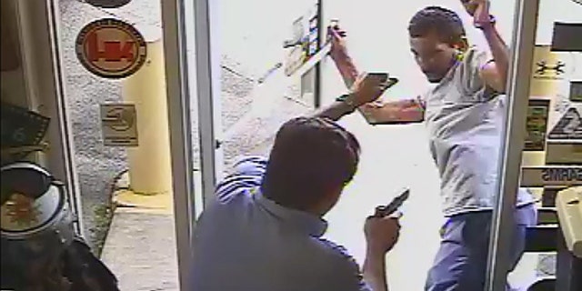 The moment before Lakeland Commissioner Michael Dunn opens fire on Cristobal Lopez, who he confronted for allegedly stealing a hatchet from his store.
