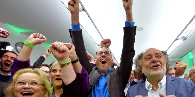 Supporters of the Green party celebrate after the state election in the German state of Hesse in Wiesbaden, western Germany, Sunday, Oct. 28, 2018. Exit polls show Chancellor Angela Merkel’s party leading with a significant drop in support for both her conservatives and their center-left partners in the national government. (Uwe Anspach/dpa via AP)