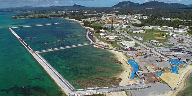 FILE - This Aug. 2018, file aerial photo shows preliminary construction work off Henoko, in Nago city, Okinawa prefecture, Japan, where the Japanese government plans to relocate a U.S. air base from one area of Okinawa's main island to another. Denny Tamaki, the newly elected governor of the southern Japanese island of Okinawa, was chosen in a Sept. 30 election, running on a campaign that rejected the U.S. base being built on coastal Henoko. He defeated, by a comfortable margin, the candidate backed by the ruling party, eager to go ahead with Henoko, whose construction has been on hold. (Koji Harada/Kyodo News via AP, File)