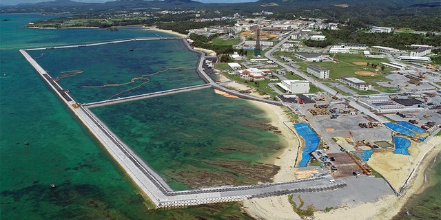 FILE - This Aug. 2018, file aerial photo shows preliminary construction work off Henoko, in Nago city, Okinawa prefecture, Japan, where the Japanese government plans to relocate a U.S. air base from one area of Okinawa's main island to another. Denny Tamaki, the newly elected governor of the southern Japanese island of Okinawa, was chosen in a Sept. 30 election, running on a campaign that rejected the U.S. base being built on coastal Henoko. He defeated, by a comfortable margin, the candidate backed by the ruling party, eager to go ahead with Henoko, whose construction has been on hold. (Koji Harada/Kyodo News via AP, File)