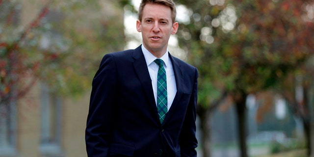 In this Nov. 8, 2016 file photo, Democratic U.S. Senate candidate Jason Kander waits to greet voters outside a polling place in St. Louis, Missouri.