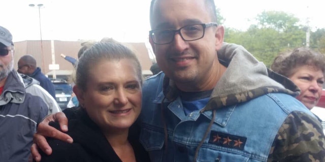 Maria Lisante, the owner of La Bella Pizza Bistro in New Paltz, New York, with her friend, Joey Garcia, a New York state corrections officers and veteran, who organized the "American flag appreciation walk" Sunday in support of the American flag mural at her business.