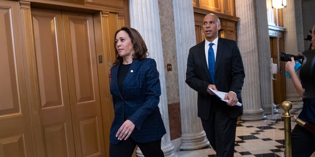 Senate Judiciary Committee members Sen. Kamala Harris, D-Calif., left, and Sen. Cory Booker, D-N.J., arrive at the chamber for the final vote to confirm Supreme Court nominee Brett Kavanaugh, at the Capitol in Washington.