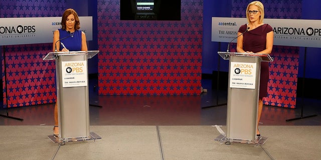 U.S. Senate candidates, U.S. Rep. Martha McSally, R-Ariz., left, and U.S. Rep. Kyrsten Sinema, D-Ariz., prepare their remarks in a television studio prior to a televised debate.