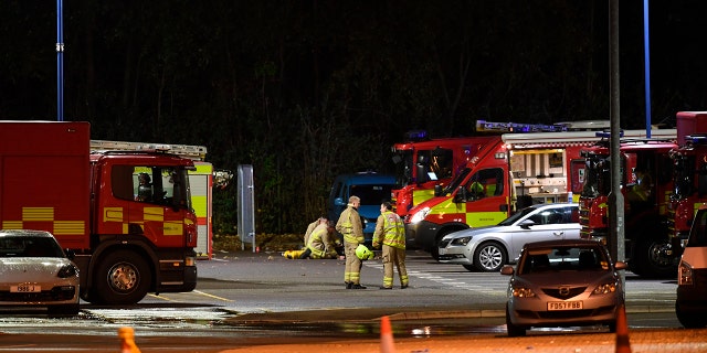 Emergency personnel stand outside the King Power Stadium in Leicester, England after a helicopter belonging to Leicester City Football Club owner Vichai Srivaddhanaprabha crashed in a parking lot. (Joe Giddens/PA via AP)