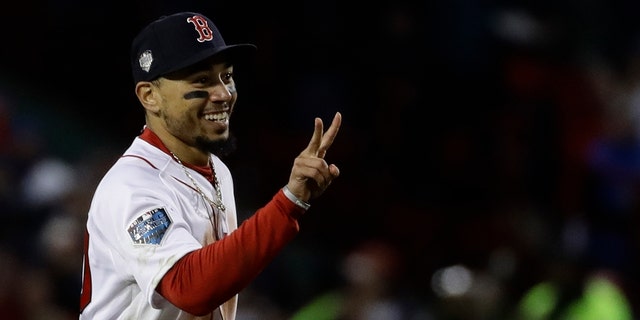 Boston Red Sox's Mookie Betts celebrates after Game 2 of the World Series baseball game against the Los Angeles Dodgers Wednesday, Oct. 24, 2018, in Boston. The Red Sox won 4-2 to take a 2-0 lead in the series.
