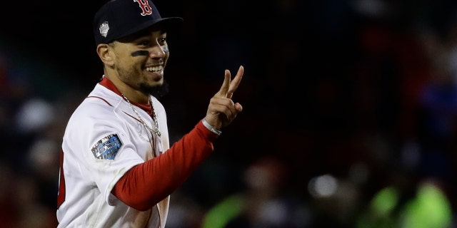 Boston Red Sox's Mookie Betts celebrates after Game 2 of the World Series baseball game against the Los Angeles Dodgers Wednesday, Oct. 24, 2018, in Boston. The Red Sox won 4-2 to take a 2-0 lead in the series.