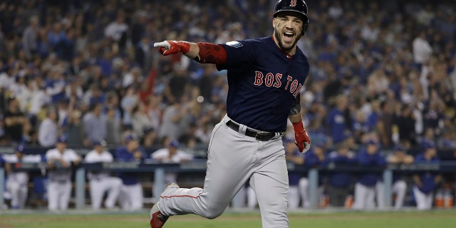 Boston Red Sox's Steve Pearce celebrates his second home run during the eighth inning in Game 5 of the World Series baseball game against the Los Angeles Dodgers on Sunday, Oct. 28, 2018, in Los Angeles.