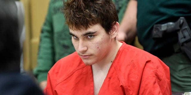FILE - Florida school shooting suspect Nikolas Cruz looks up while in court for a hearing in Fort Lauderdale, Fla.