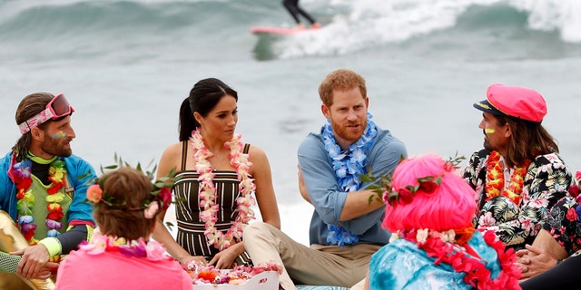 British Prince Harry and Meghan, the Duchess of Sussex, meet a local community surfing group, known as OneWave, in Bondi Beach, Sydney, Australia, on Friday, October 19, 2018.