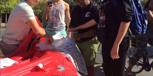 Several students ripped up signs and one was arrested on battery charges during a pro-Kavanaugh event Tuesday.