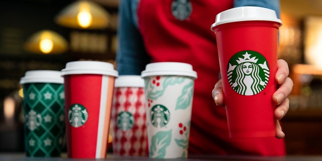 The new cups, along with a limited edition reusable cup (right), will be available starting Nov. 2.