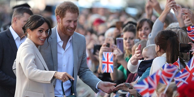 Britain's Prince Harry and Meghan, the Duchess of Sussex greet well wishers duringwell-wishers to Chichester, south east England, Wednesday Oct. 3, 2018. The Duke and Duchess of Sussex made their first joint official visit to Sussex.