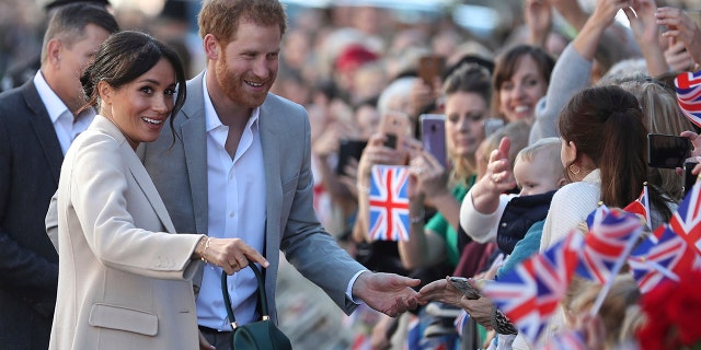 Britain's Prince Harry and Meghan, the Duchess of Sussex greet well wishers during their visit to Chichester, south east England, Wednesday Oct. 3, 2018. The Duke and Duchess of Sussex made their first joint official visit to Sussex. (Daniel Leal-Olivas/Pool via AP)
