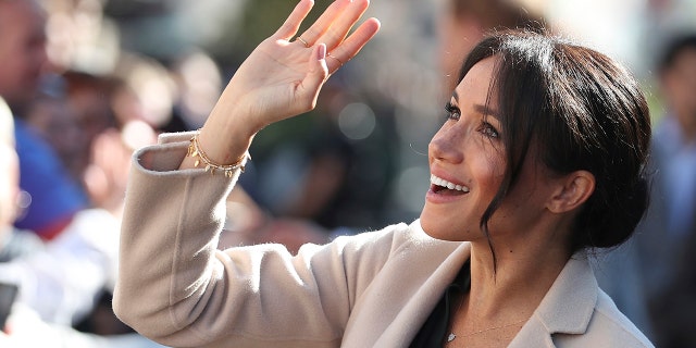 Britain's Meghan, the Duchess of Sussex greets well wishers as she and Prince Harry visit Chichester, south east England, Wednesday Oct. 3, 2018. The Duke and Duchess of Sussex made their first joint official visit to Sussex. (Daniel Leal-Olivas/Pool via AP)