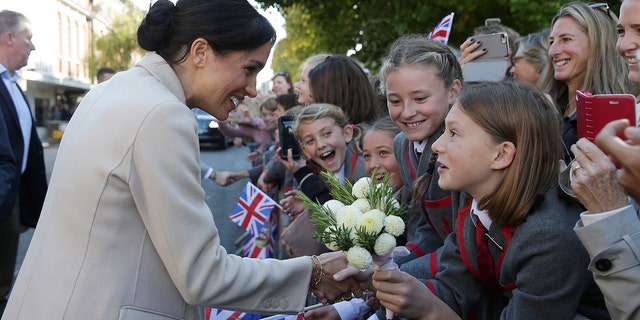 Britain's Meghan, the Duchess of Sussex greets well wishers as she and Prince Harry visit Chichester, south east England, Wednesday Oct. 3, 2018. The Duke and Duchess of Sussex made their first joint official visit to Sussex.