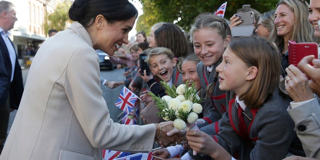 Britain's Meghan, the Duchess of Sussex greets well wishers as she and Prince Harry visit Chichester, south east England, Wednesday Oct. 3, 2018. The Duke and Duchess of Sussex made their first joint official visit to Sussex. (Daniel Leal-Olivas/Pool via AP)
