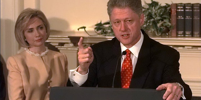 President Bill Clinton shakes his finger as he denies improper behavior with Monica Lewinsky, in the White House Roosevelt Room. "I did not have sexual relations with that woman," Clinton said. First Lady Hillary Rodham Clinton stands by her man.