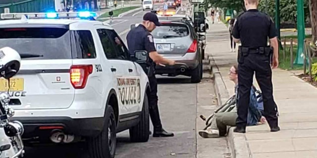 Thomas Metcalf, an Indiana University junior, was detained by police after vandalizing anti-abortion signs on campus.