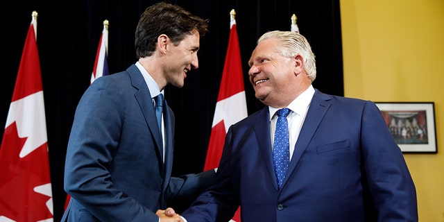 Civil for now: Prime Minister Trudeau meets with Premier Doug Ford in Toronto earlier this year; they have been at loggerheads over Trudeau's carbon tax
