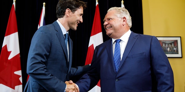 Civil for now: Prime Minister Trudeau meets with Premier Doug Ford in Toronto earlier this year; they have been at loggerheads over Trudeau's carbon tax