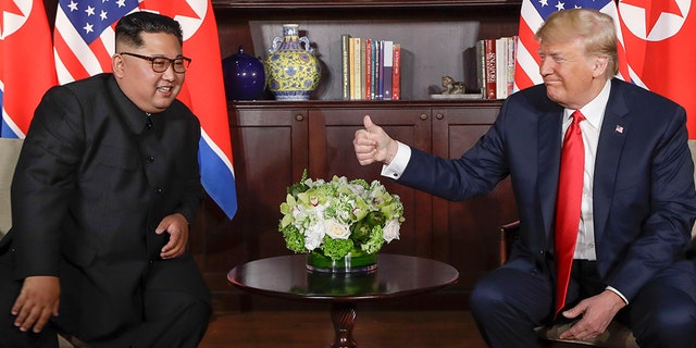 President Trump congratulates North Korean leader Kim Jong Un at their meeting at the Capella Complex on Sentosa Island on Tuesday, June 12, 2018 in Singapore. 