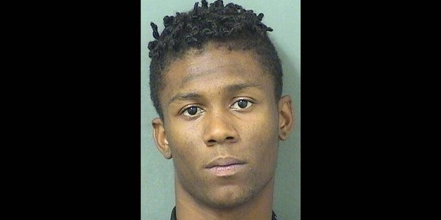 Xavier Martin, 19, was arrested after police say he showed his gun to a group of praying football students on the grounds of Palm Beach Lakes Community High School.
