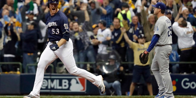 Milwaukee Brewers' Brandon Woodruff (53) celebrates after hitting a home run during the third inning of Game 1 of the National League Championship Series baseball game against the Los Angeles Dodgers Friday, Oct. 12, 2018, in Milwaukee. 