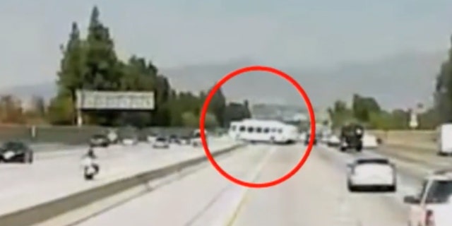 The bus can be seen slamming into the concrete divider on the 405 Freeway on Sunday.