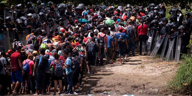 The Mexican Federal Police meet a new group of Central American migrants after they have massively massed across the Suchiate River, which connects Guatemala and Mexico, to Tecun Uman, Guatemala.