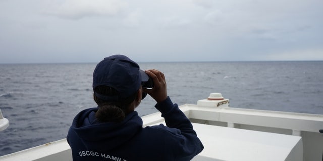 A Coast Guard Cutter Hamilton crew member searches for a downed civilian aircraft Oct. 27, 2018, 110 miles east of Charleston, South Carolina.