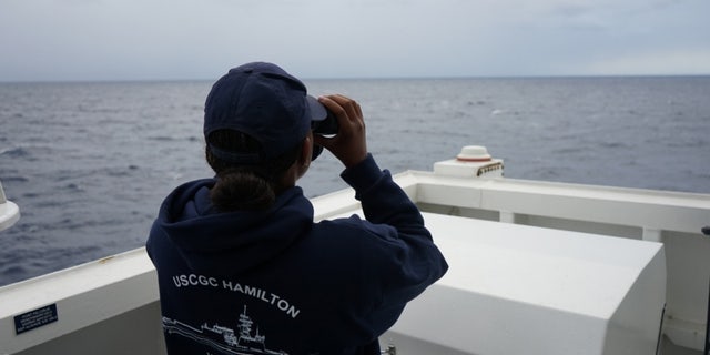 A Coast Guard Cutter Hamilton crew member searches for a downed civilian aircraft Oct. 27, 2018, 110 miles east of Charleston, South Carolina.