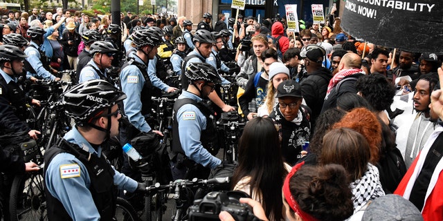 Protesters stand near police in downtown after a jury said Chicago police officer, Jason Van Dyke, guilty of second degree murder, during the Laquan McDonald shootout , black teenager, on Friday, October 5, 2018 in Chicago. 