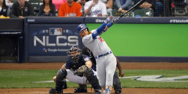 Los Angeles Dodgers' Justin Turner (10) hits a two-run home run during the eighth inning of Game 2 of the National League Championship Series baseball game against the Milwaukee Brewers Saturday, Oct. 13, 2018, in Milwaukee.