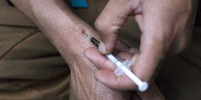 A man injects himself with heroin using a needle obtained from the People's Harm Reduction Alliance, the nation's largest needle-exchange program, in Seattle, Washington April 30, 2015.