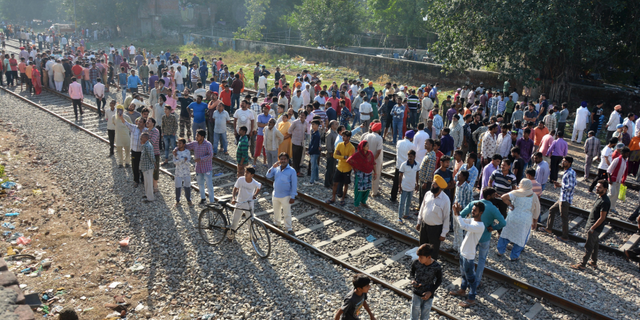 A crowd gathers at the site of Friday's train accident in Amritsar, India, Saturday, Oct. 20, 2018. A speeding train ran over a crowd watching fireworks during a religious festival in northern India on Friday evening, killing more than 50 people and injuring dozens more, police said.