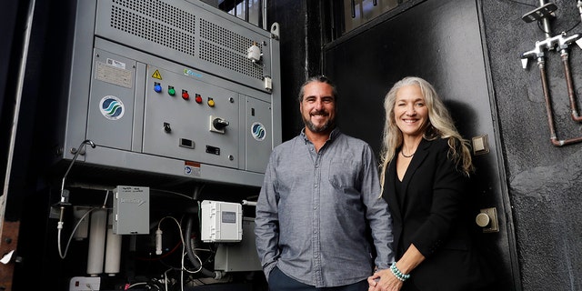 The Skysource/Skywater Alliance co-founders David Hertz, left, and his wife Laura Doss-Hertz pose for a portrait next to the Skywater 300 Wednesday in Los Angeles.