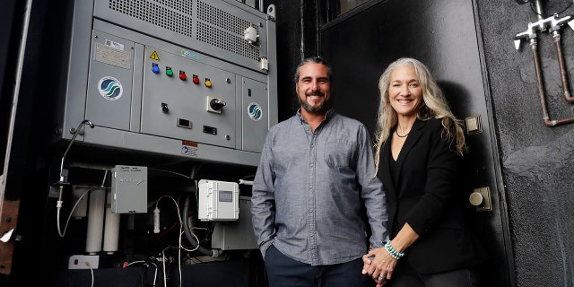 The Skysource/Skywater Alliance co-founders David Hertz, left, and his wife Laura Doss-Hertz pose for a portrait next to the Skywater 300 Wednesday in Los Angeles.