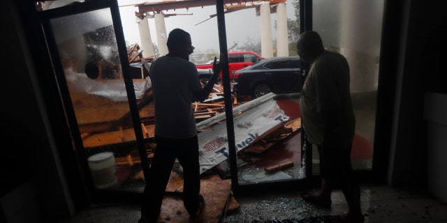 .Hotel employees look at a canopy that just collapsed, as Hurricane Michael passes through in Panama City Beach