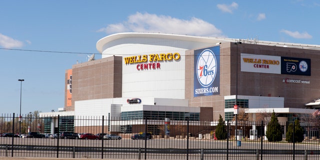 A basketball fan claims she was barred from entering because of her outift.