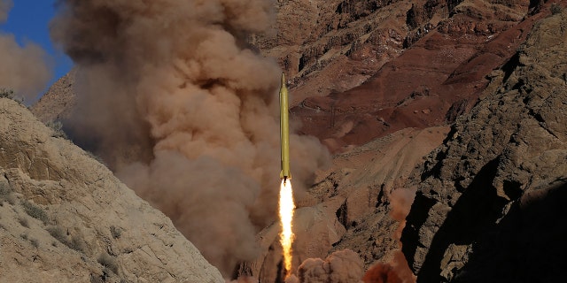 In this March 9, 2016 file photo obtained from the Iranian Fars News Agency, a Qadr H long-range ballistic surface-to-surface missile is fired by Iran's powerful Revolutionary Guard, during a maneuver, in an undisclosed location in Iran.