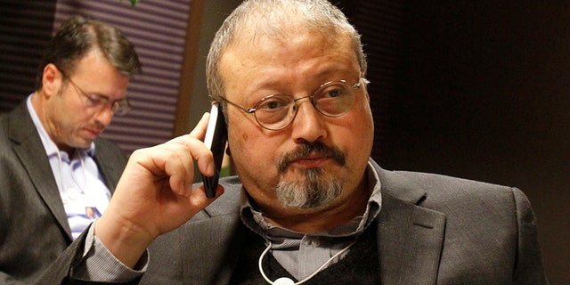 Saudi Arabian journalist Jamal Khashoggi speaks on his cell phone at the World Economic Forum in Davos, Switzerland, in 2011.